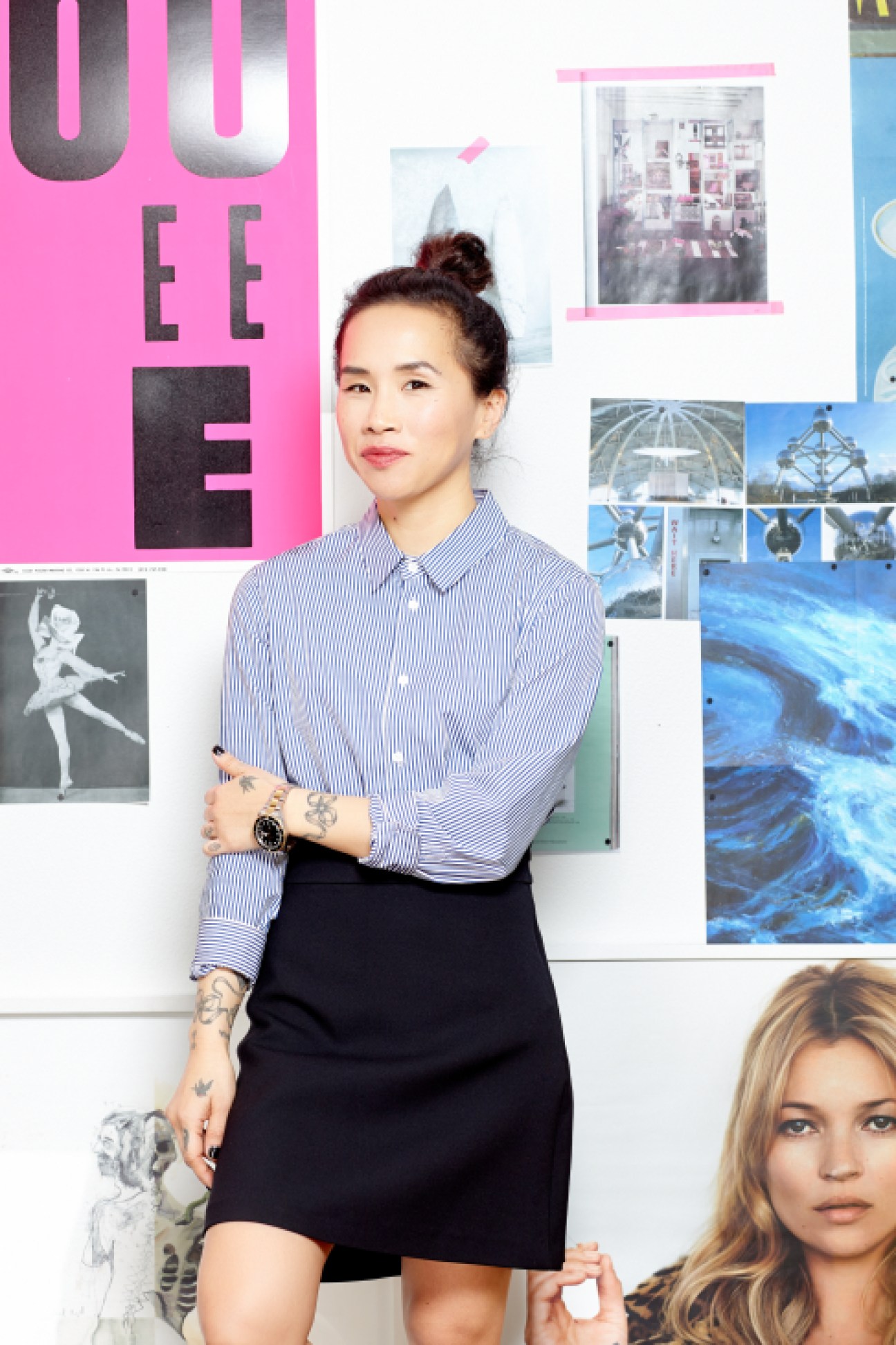 Olivia Kim, VP of Creative Projects at Nordstrom, stands in front of a mood board with pink signage and various images.