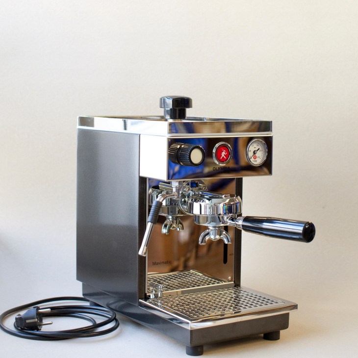 Olympia Maximatic espresso machine with chrome and black finish against white background