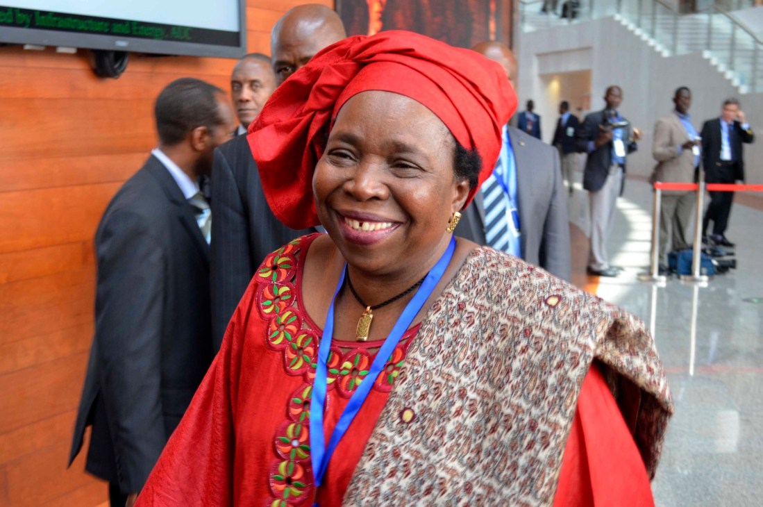 Nkosazana Dlamini-Zuma wearing red traditional dress and blue lanyard at African Union event.
