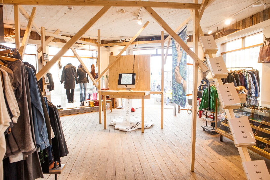 Interior of Or Type shop in Reykjavík showing wooden structural beams, clothing displays, and wooden signage.