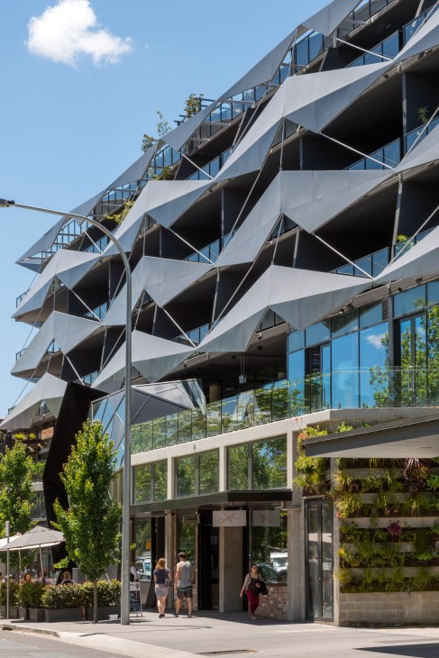 Modern multi-storey apartment building with angular white balconies and large windows in Braddon, Canberra.