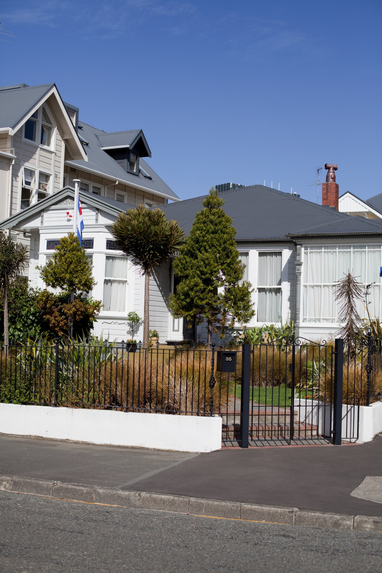 White villa with black iron fence housing the Cuban Embassy in Wellington, New Zealand.