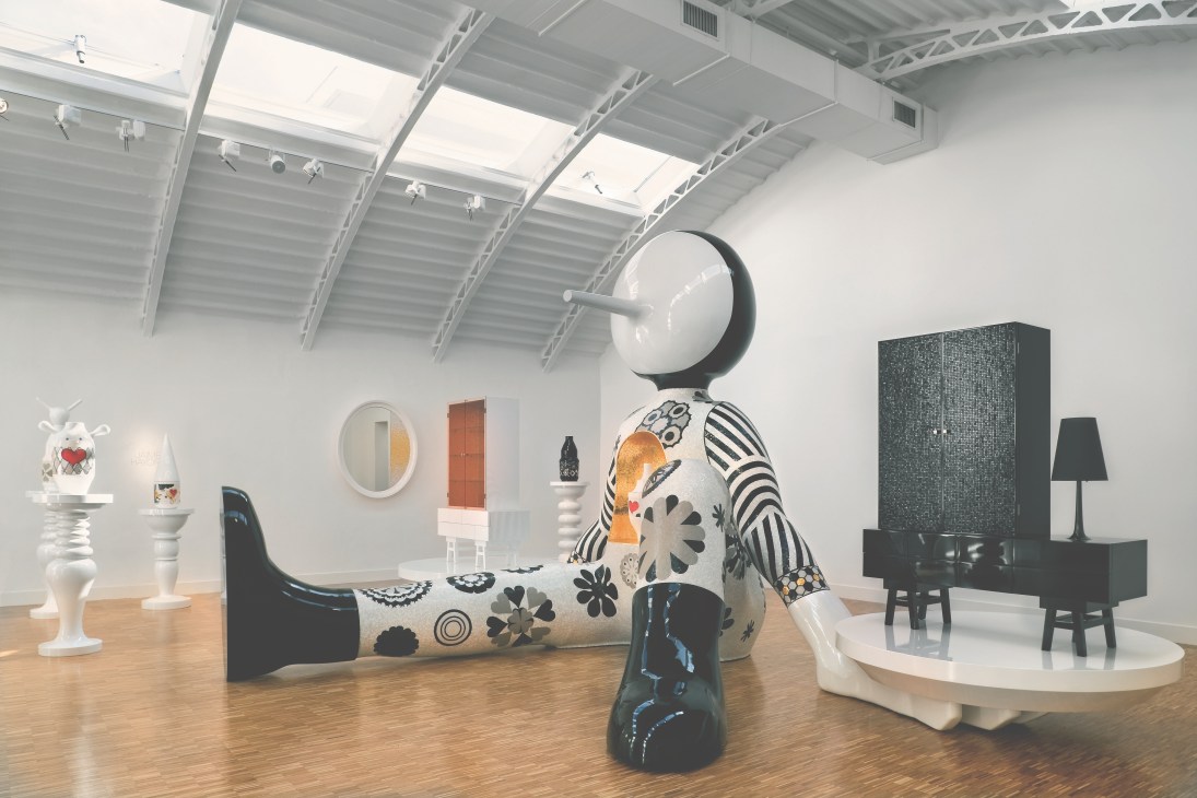 Interior of the Bisazza Foundation showing ceramic and mosaic installations and designer furniture in a modern gallery space.