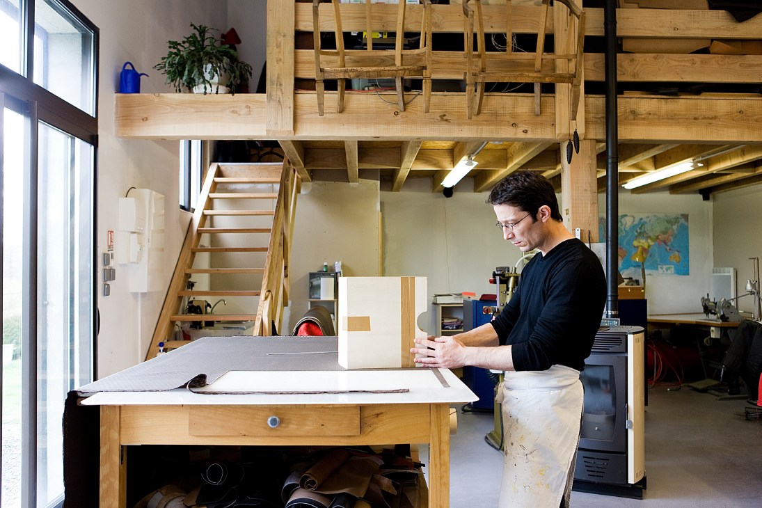 Artisan Frank Tioni working on a Moynat trunk in his workshop.