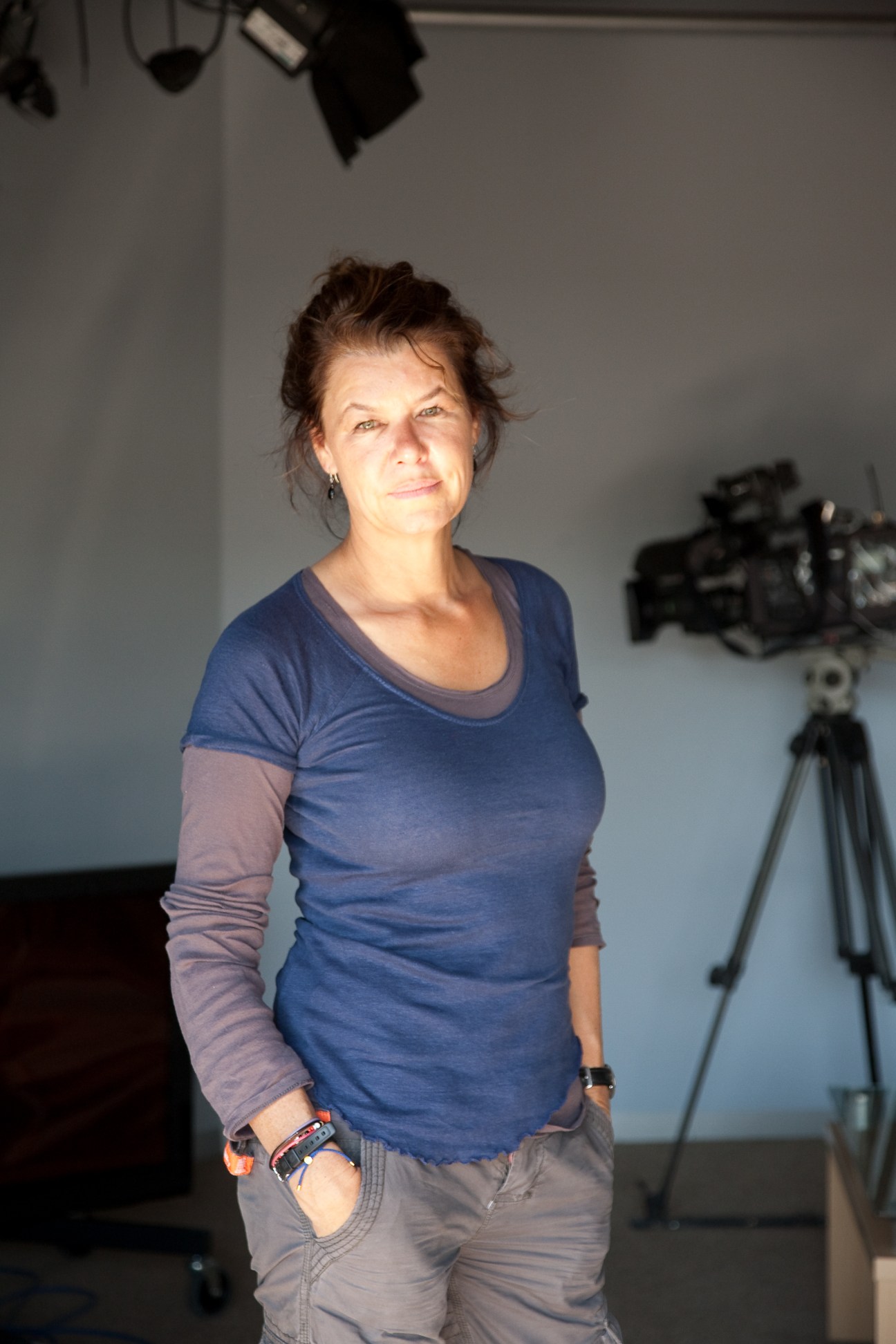 Sky News special correspondent Alex Crawford standing in studio with camera equipment on tripod behind her.