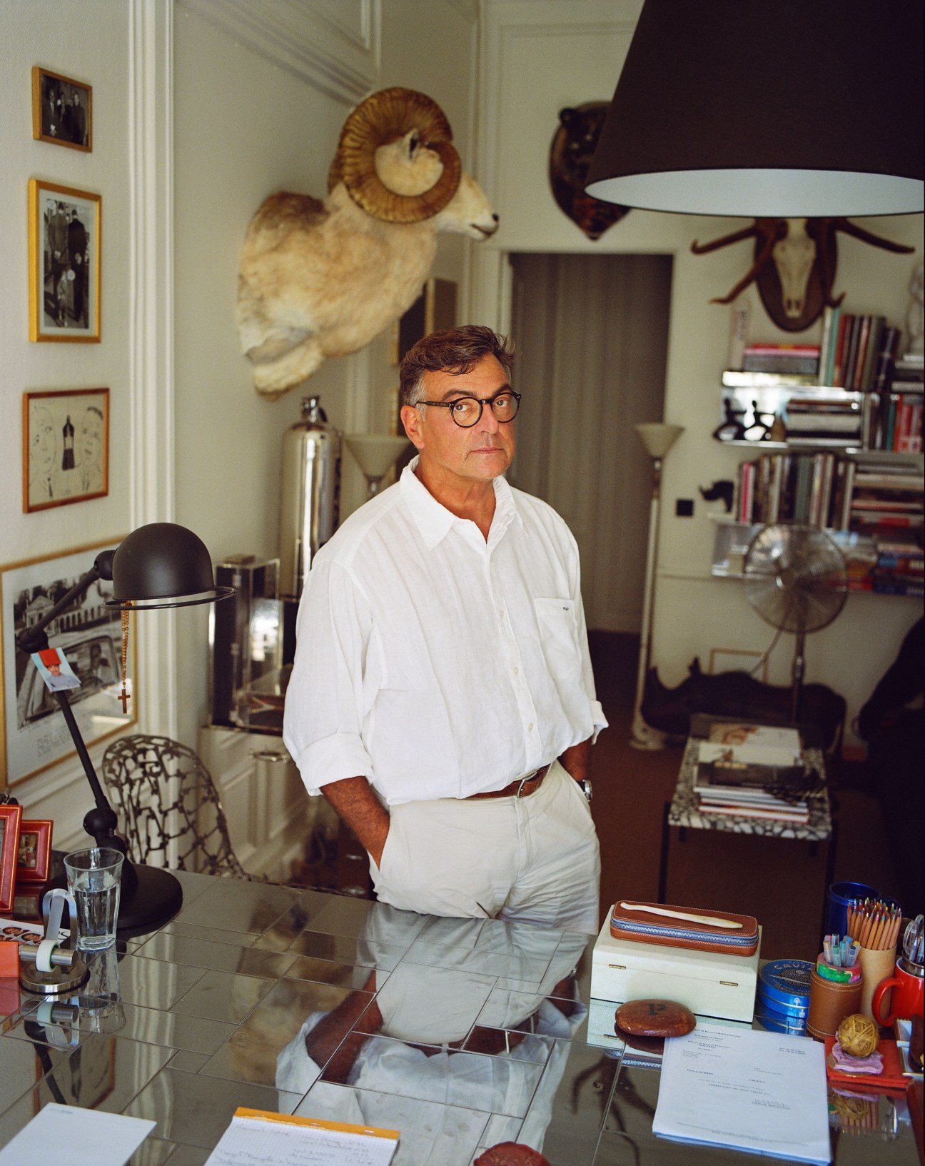 Patrick Perrin, founder of PAD fair, stands in his eclectic office surrounded by art and design objects.