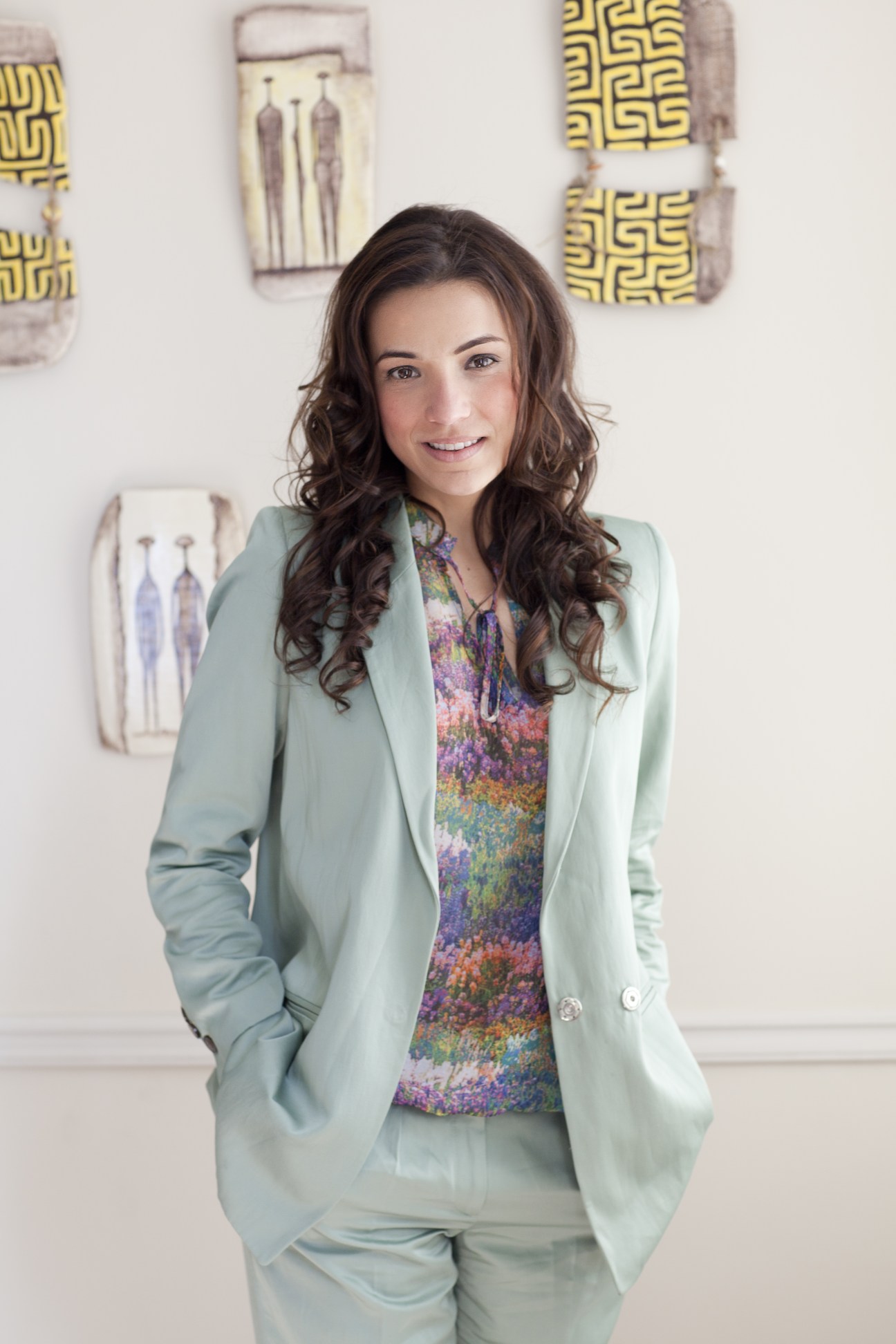 Ana Irene Delgado, Panama's ambassador to the UK, poses in a light green blazer against a white wall with geometric artwork.