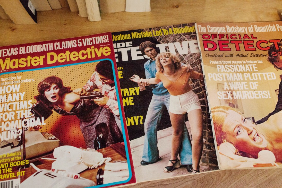 Vintage 1960s detective and true crime magazines with colorful covers displayed at The Paper Hound bookstore.