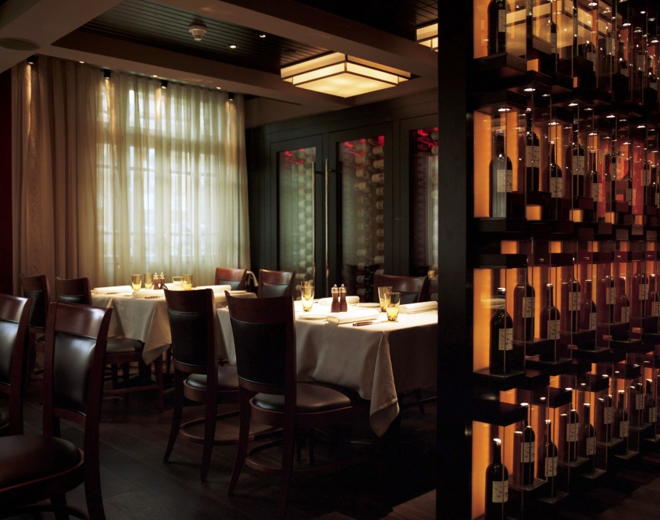 Wine selection in the Prime Restaurant at Park Hyatt Istanbul, featuring illuminated wine display cases and dining tables with white linens.