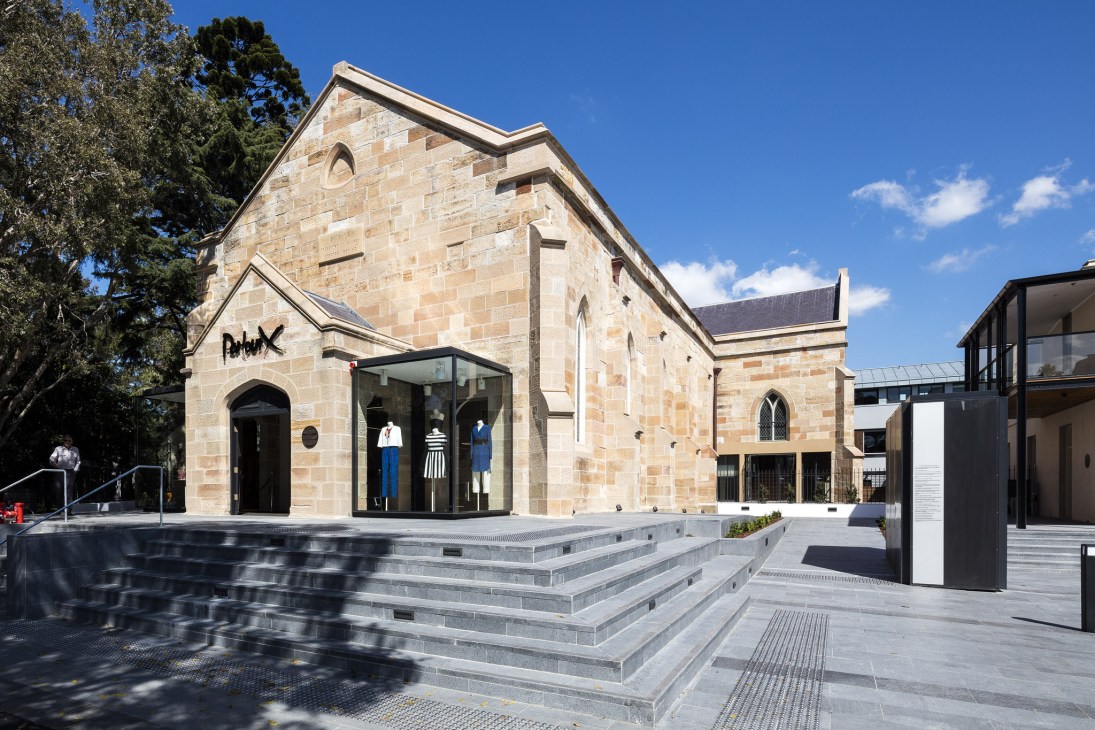 Parlour X boutique storefront housed in a restored 170-year-old sandstone church in Sydney with modern glass entrance.