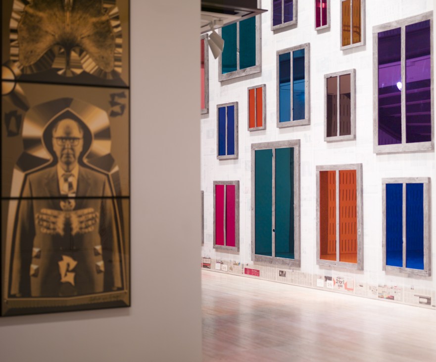 Gallery installation view showing Gilbert & George's 'Dig' on the left and Ugo Rondinone's 'Clockwork for Oracles' on the right.