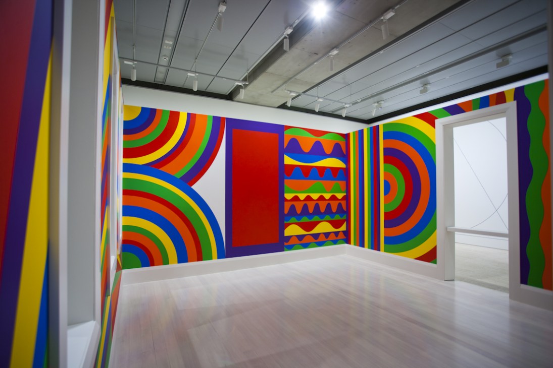 Sol LeWitt's colorful geometric wall drawing featuring concentric arcs, circles and bands in red, blue, yellow and green.