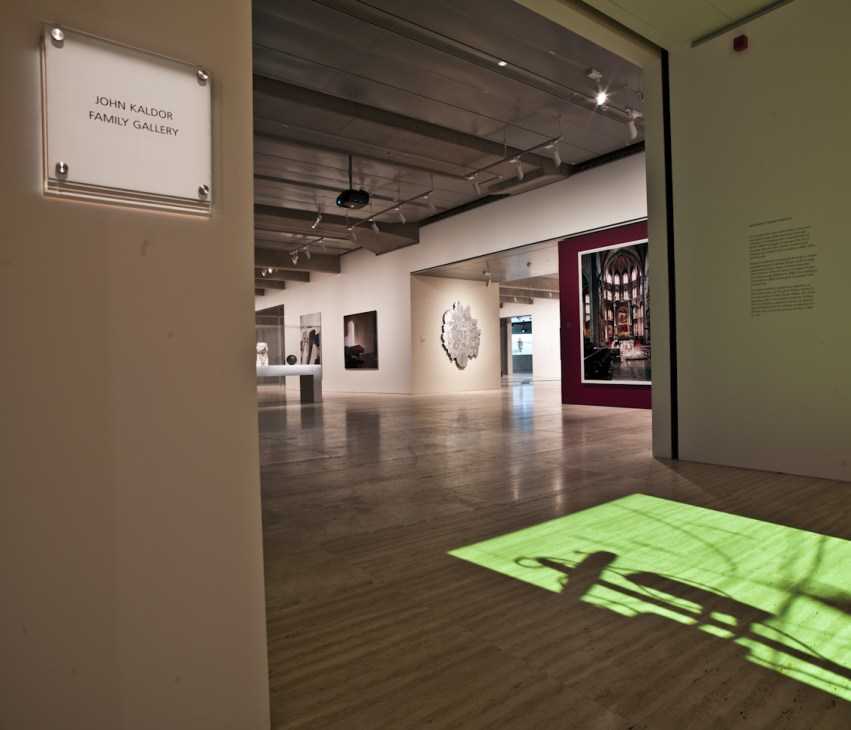 Interior of the John Kaldor Family Gallery showing white walls, gallery signage, and contemporary artworks on display