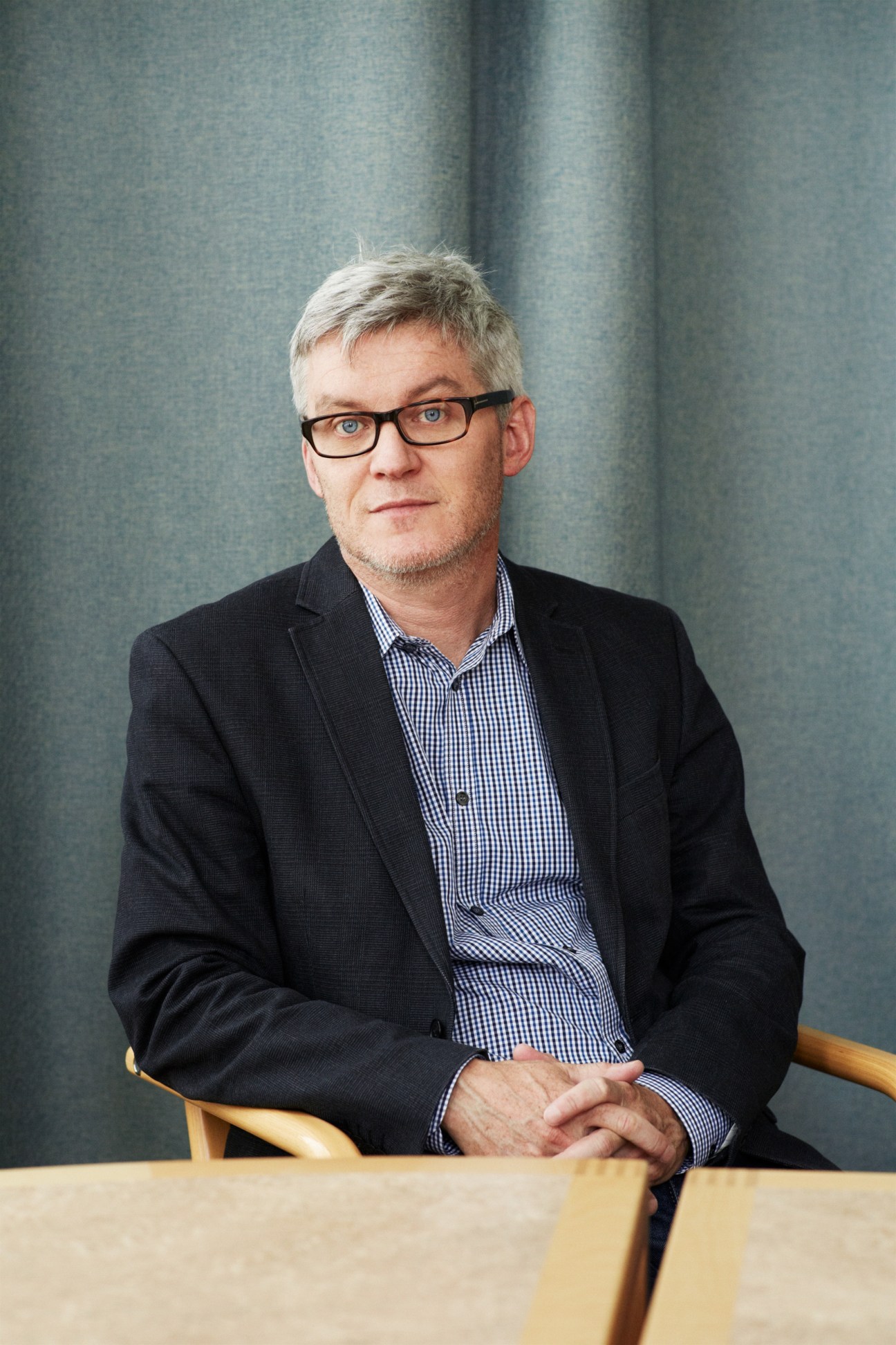 Neil Melvin, director of SIPRI's Armed Conflict and Conflict Management Programme, seated in an office chair.