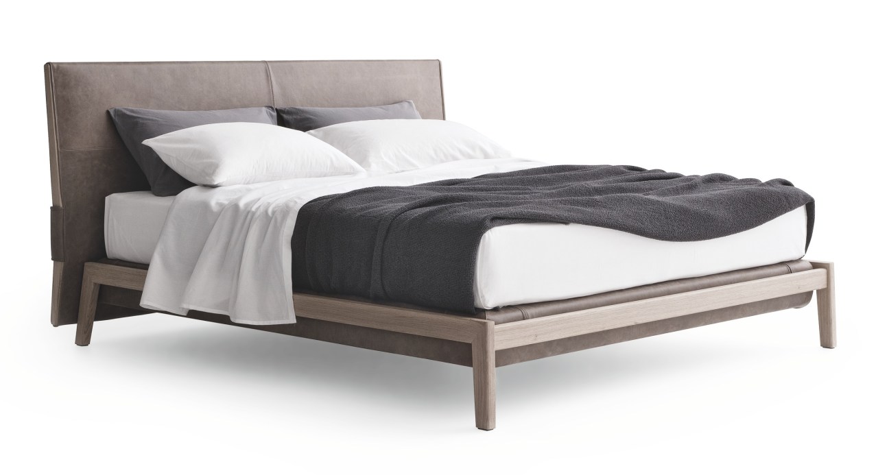Poliform's Ipanema bed by Jean-Marie Massaud with padded upholstered headboard and solid wood frame.