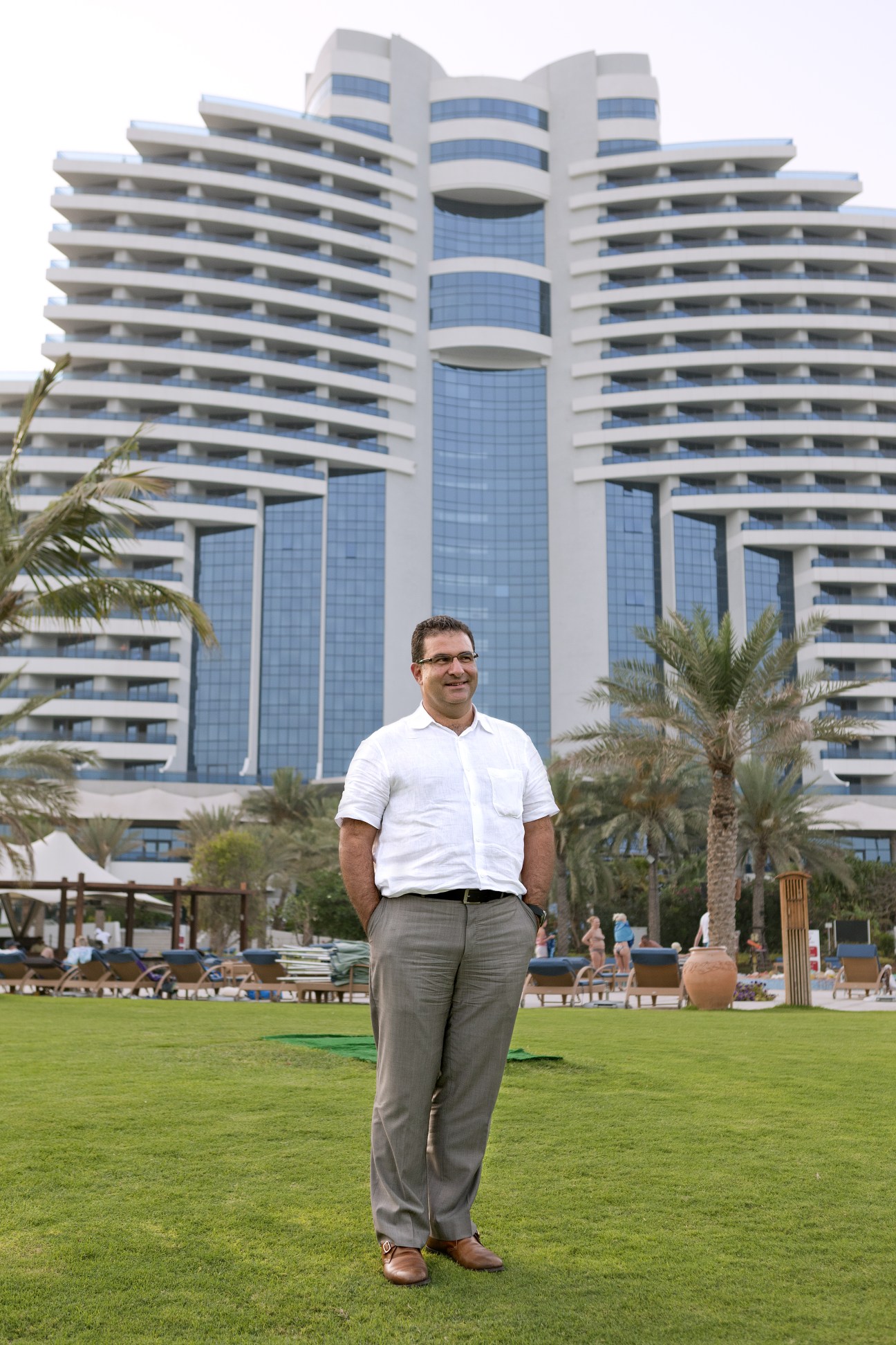 Patrick Antaki standing on a lawn in front of Le Meridien Al Aqah beach resort.
