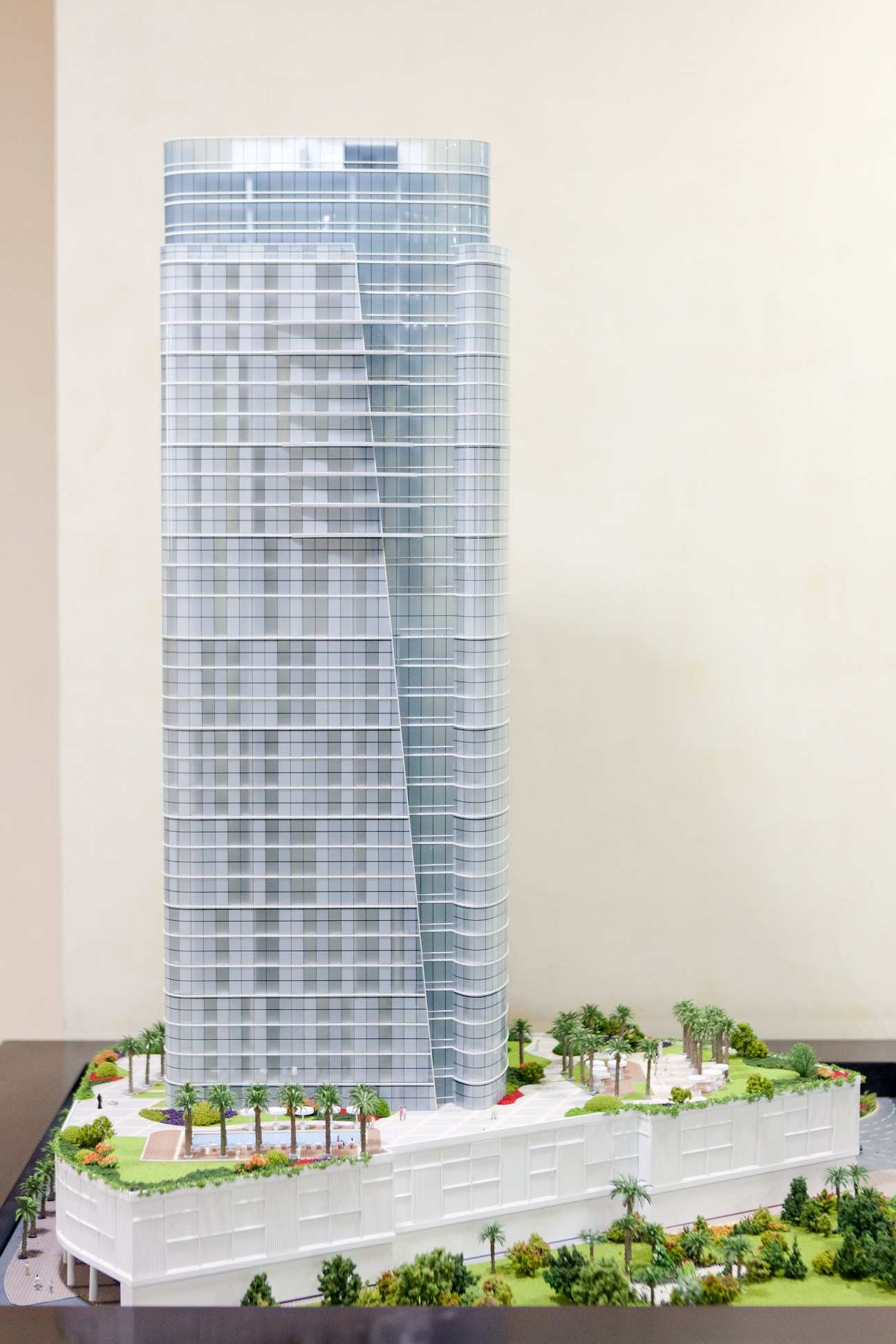 Architectural model of a tall cylindrical glass tower with curved facade from the Al Hilal City development plan in Fujairah.