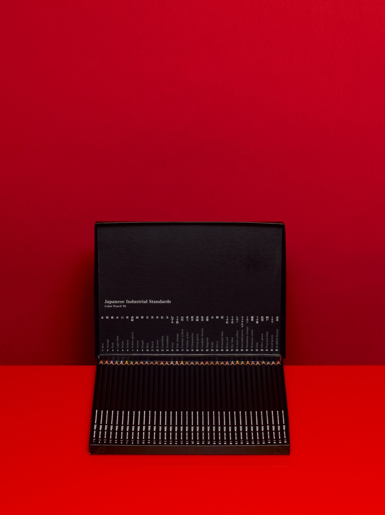 Düller Japanese coloured pencil set with black box and numbered pencils displayed against red background.