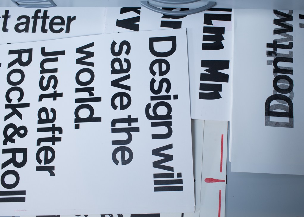 Handprinted posters with large black typography displayed in a drawer at P98a workshop.