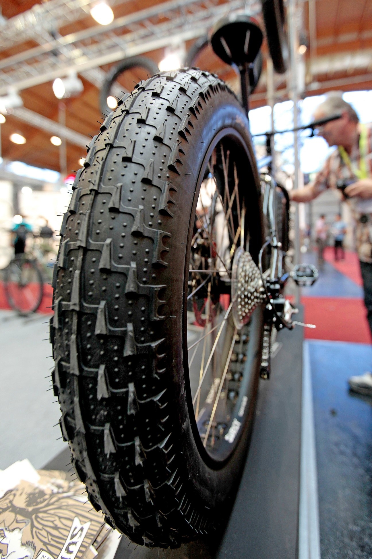 Close-up of a rugged mountain bike tire with deep tread displayed at Eurobike trade show