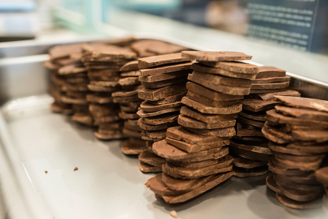 Stacks of thin chocolate portions arranged on a white surface at Marou chocolatier.