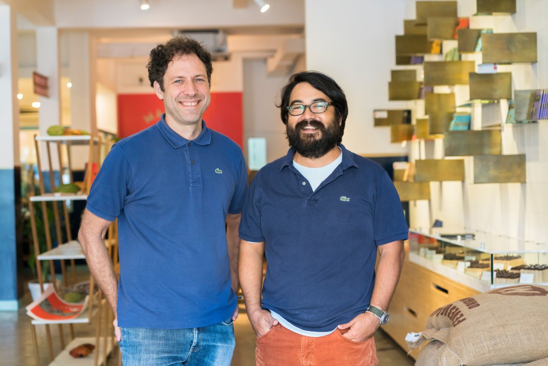 Marou founders Vincent Mourou and Samuel Maruta stand smiling in their Ho Chi Minh City chocolaterie.