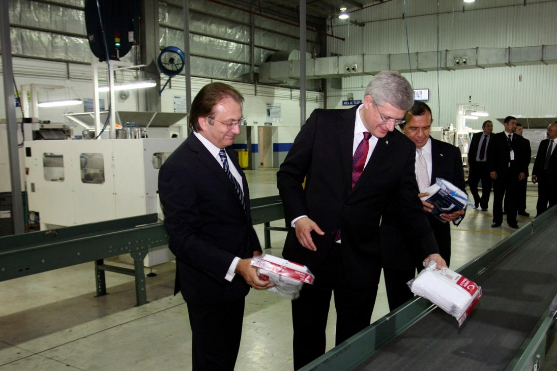 Prime Minister Stephen Harper and Honduran President Porfirio Lobo examine products during a factory tour.