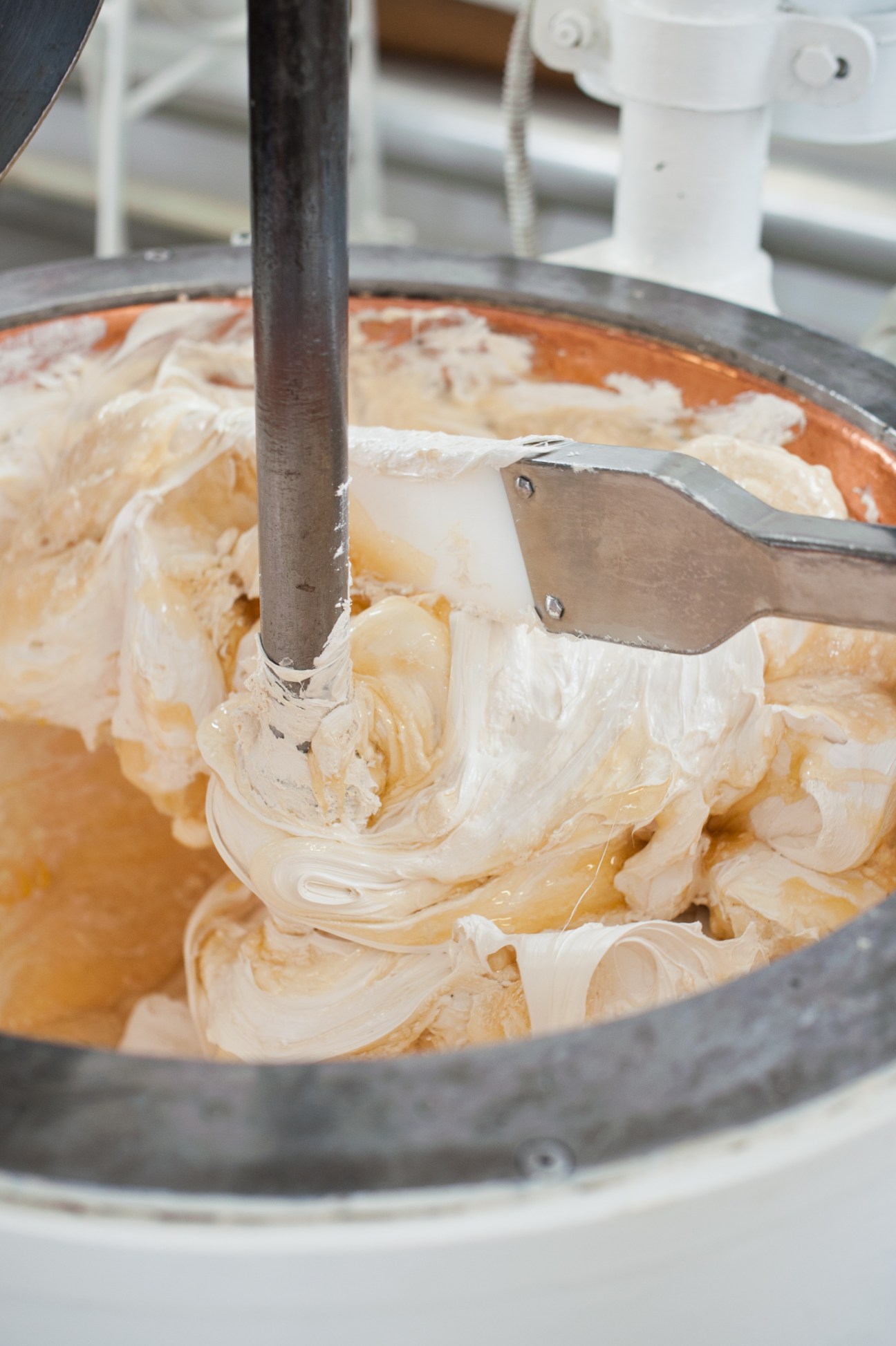 Nougat mixture being stirred in a copper vat during the heating process at Scaldaferro factory.