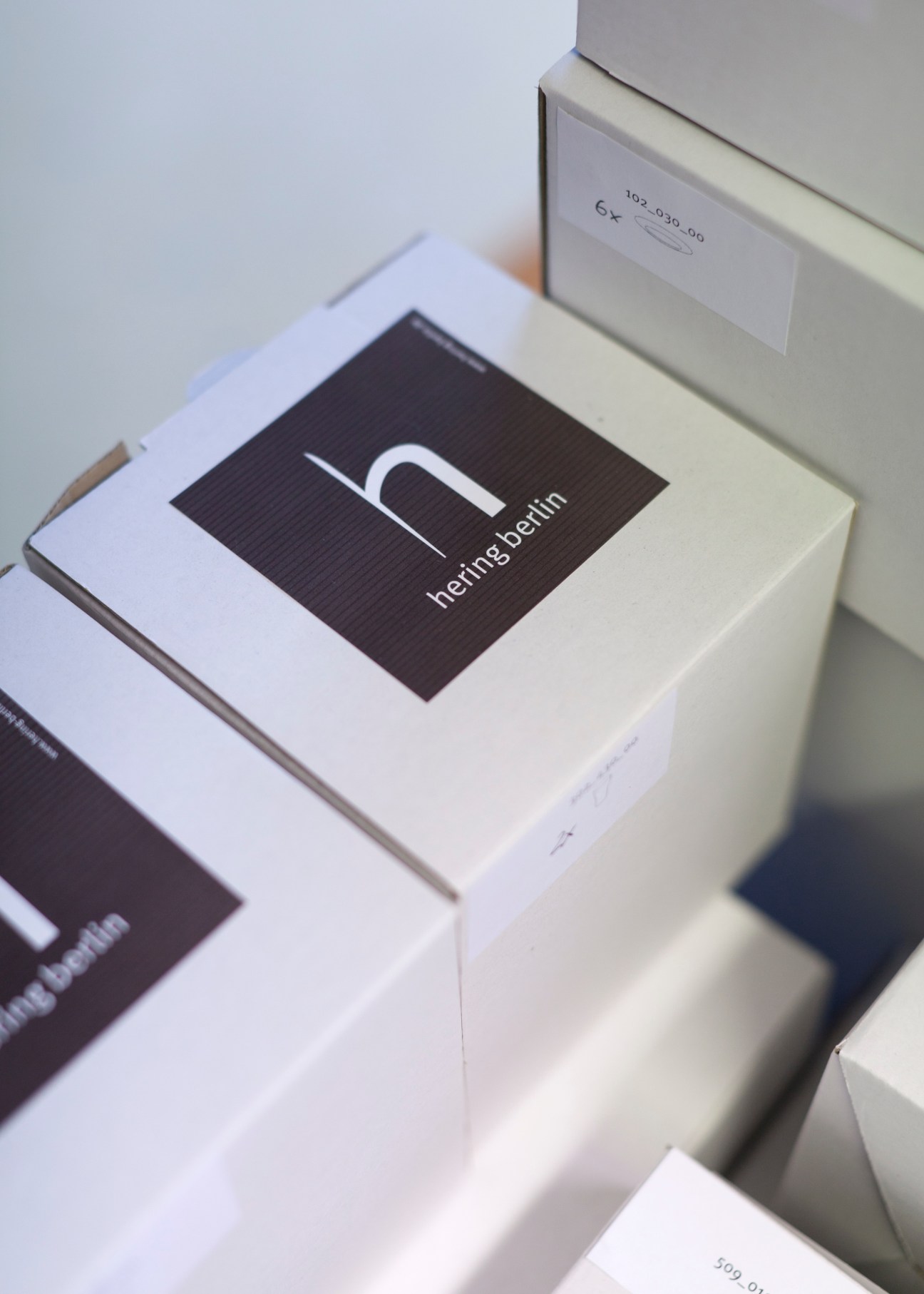 Hering Berlin porcelain packaging boxes with black logo label on white box.