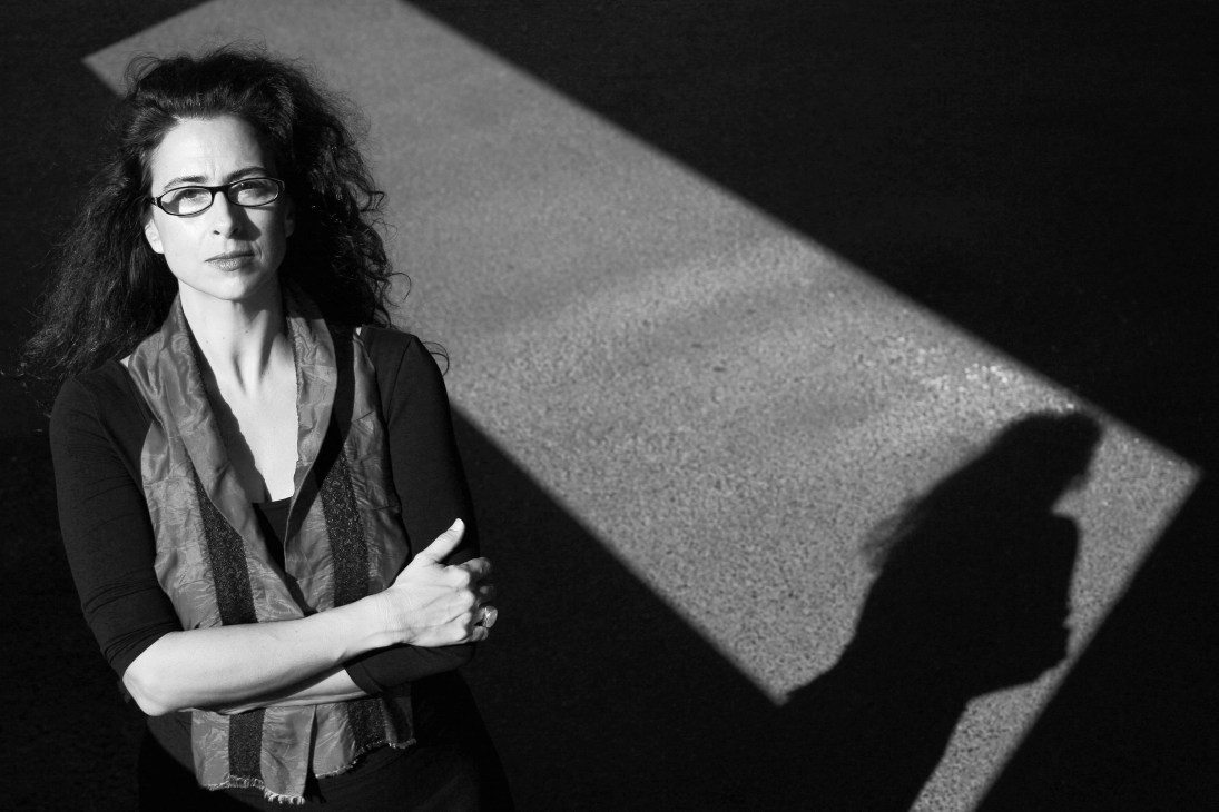 Alexandra Lucas Coelho, a Portuguese writer and Brazil correspondent, photographed in black and white portrait.