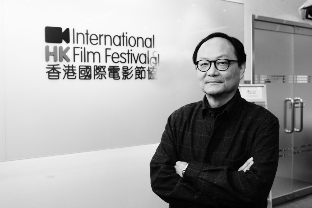 Roger Garcia, executive director of the Hong Kong Film Festival, posed in black and white against the festival's logo.