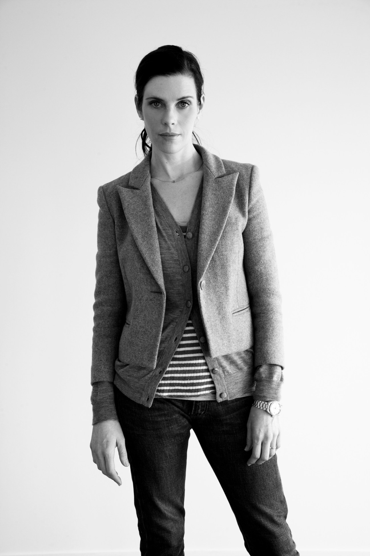 Karen Walker, fashion designer, wearing a tailored blazer and striped shirt in black and white portrait.