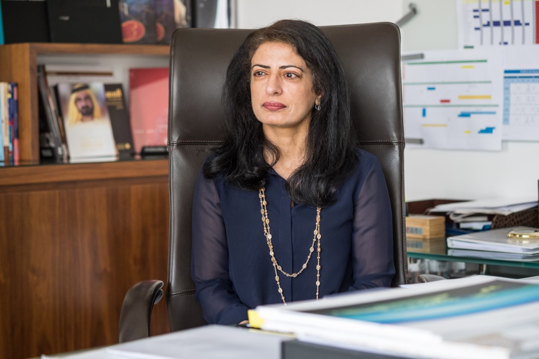 Dr Amina Al Rustamani, CEO of Tecom Group, seated at her desk in an office.