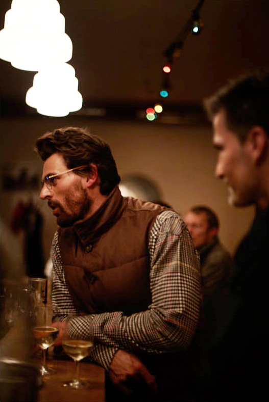 Man wearing Valstar vest and Visvim shirt at a Berlin bar with drinks