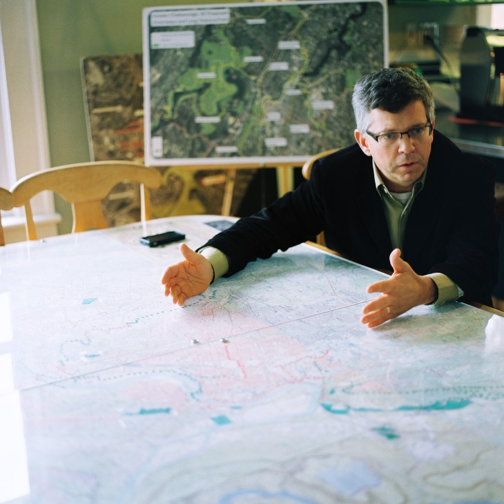 Rick Wood of the Trust for Public Land gestures over a map during a discussion.