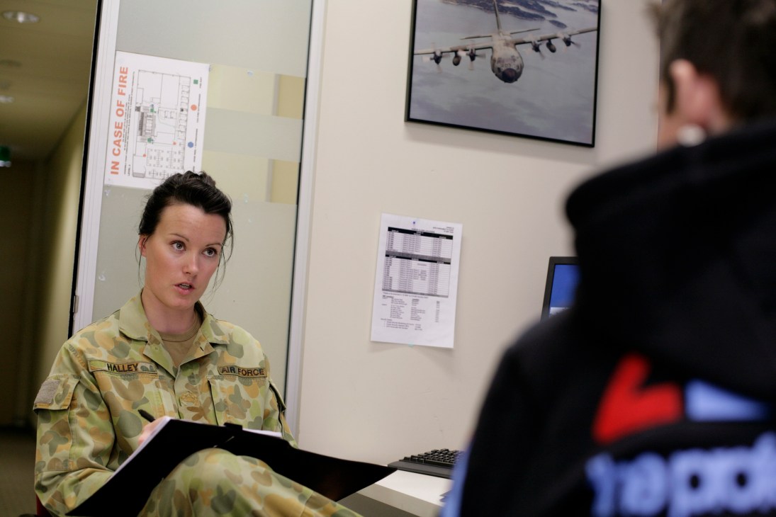 Corporal Renae Halley in Australian Air Force uniform interviewing a prospective recruit in an office setting.