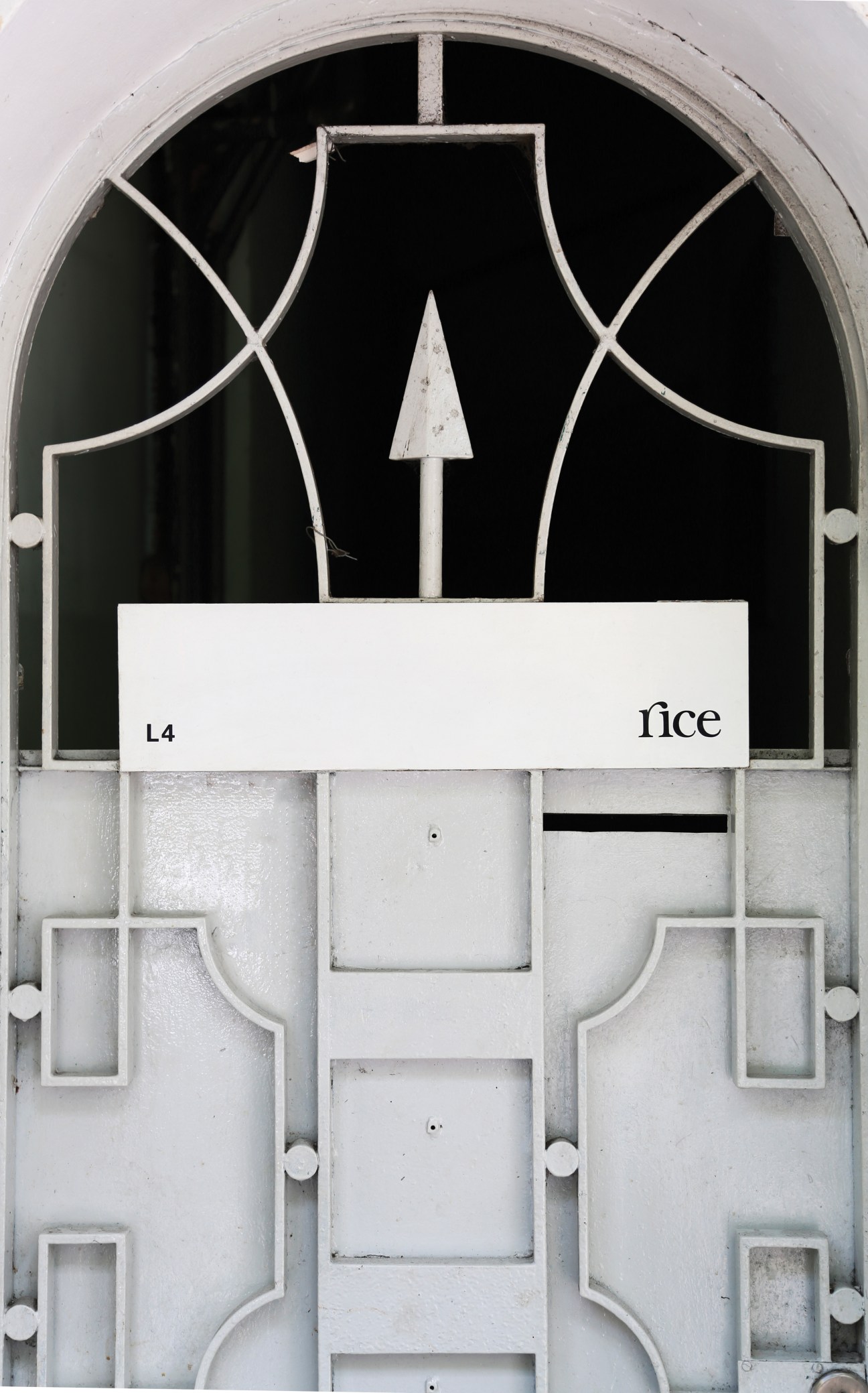 Rice Creative storefront with white signage on geometric white facade.