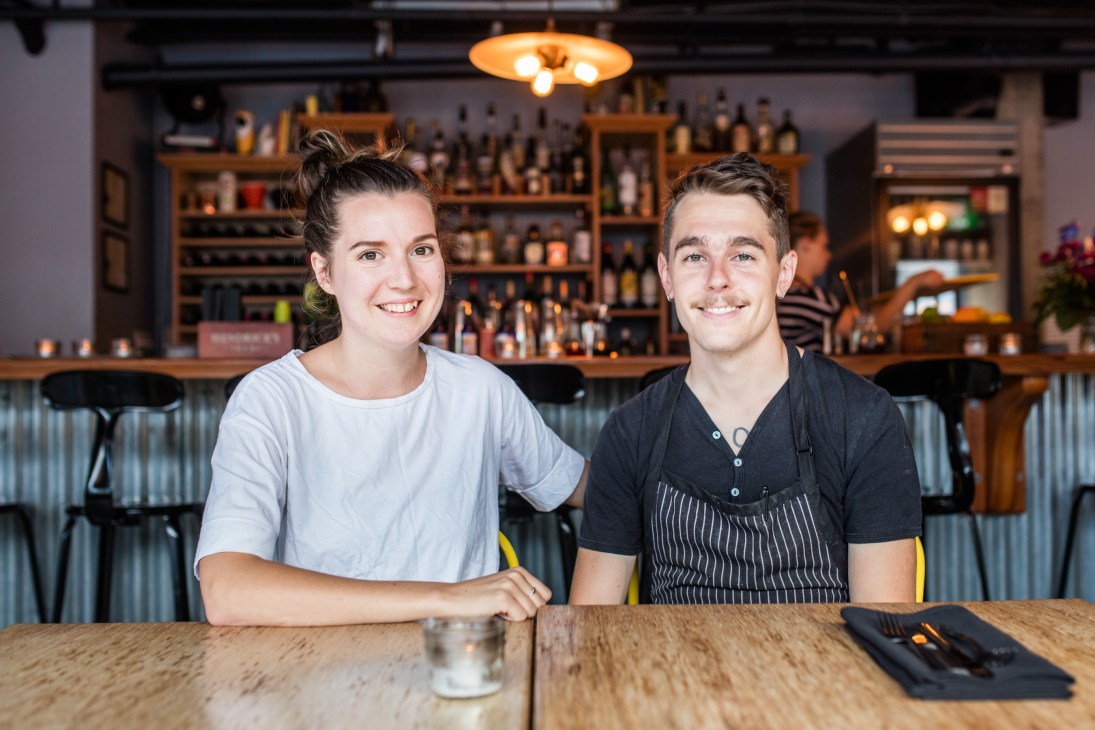Two restaurant owners Ceilidh Sutherland and Dan Vorstermans smiling at camera in their establishment