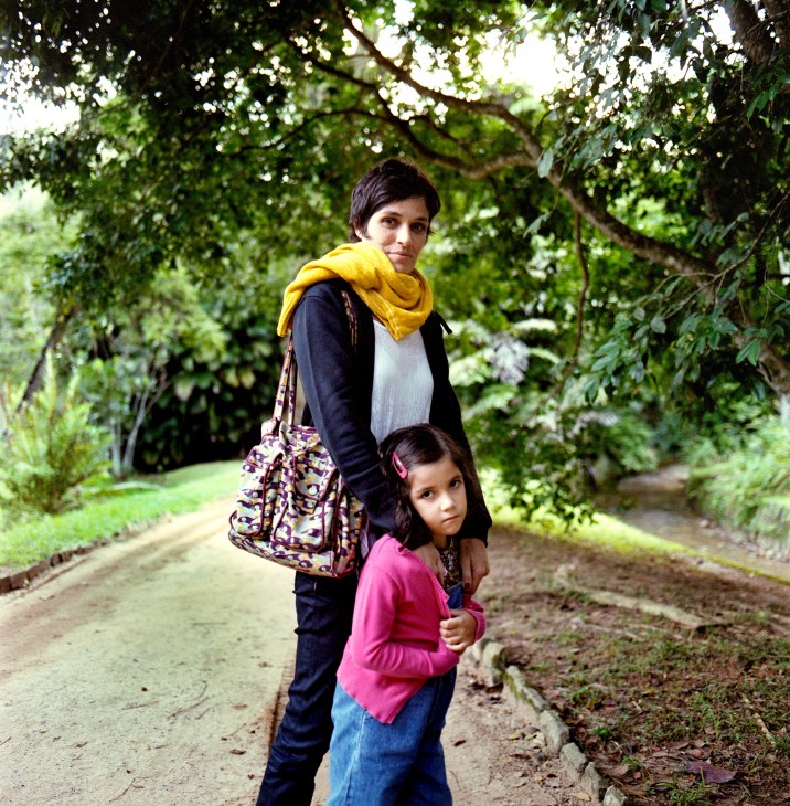 Video artist Elisa Pessoa and her daughter Zoé stand on a tree-lined path in Jardim Botânico.