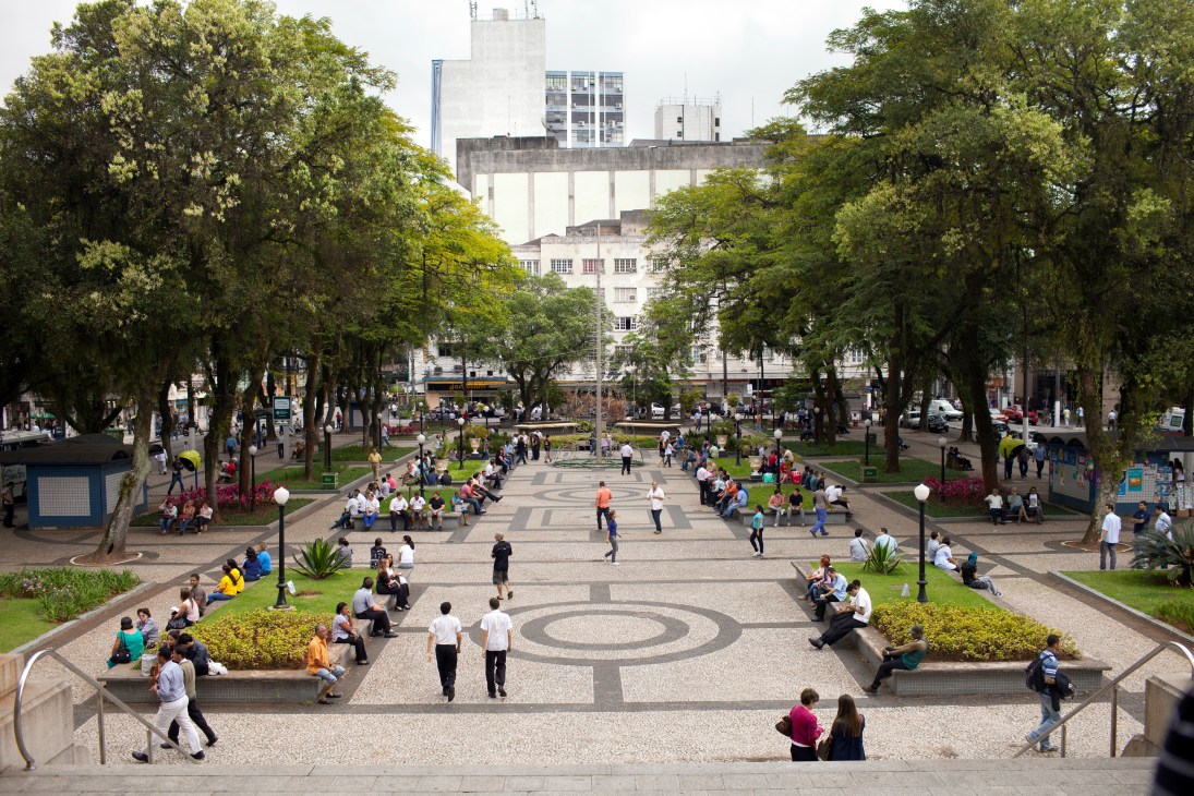 Mauá Square in front of City Hall with tree-lined plaza, geometric paving pattern, and people gathering in Santos.