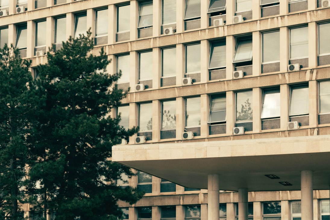 Modernist facade of the Palace of Serbia with repetitive grid of windows and a cantilevered concrete overhang.