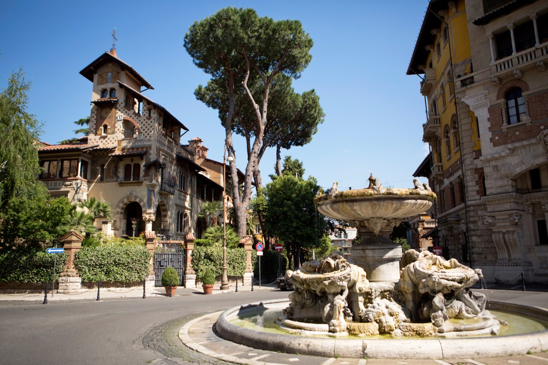 Piazza Mincio in Quartiere Coppedè with ornate tower, fountain, and historic buildings