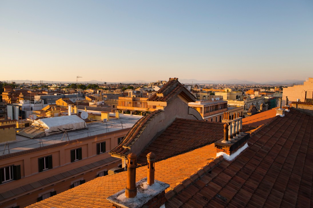 Rooftop view of terracotta buildings in Rome's Trieste neighbourhood at golden hour.