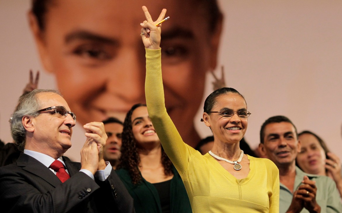 Marina Silva makes a peace gesture at a public event in Brazil.