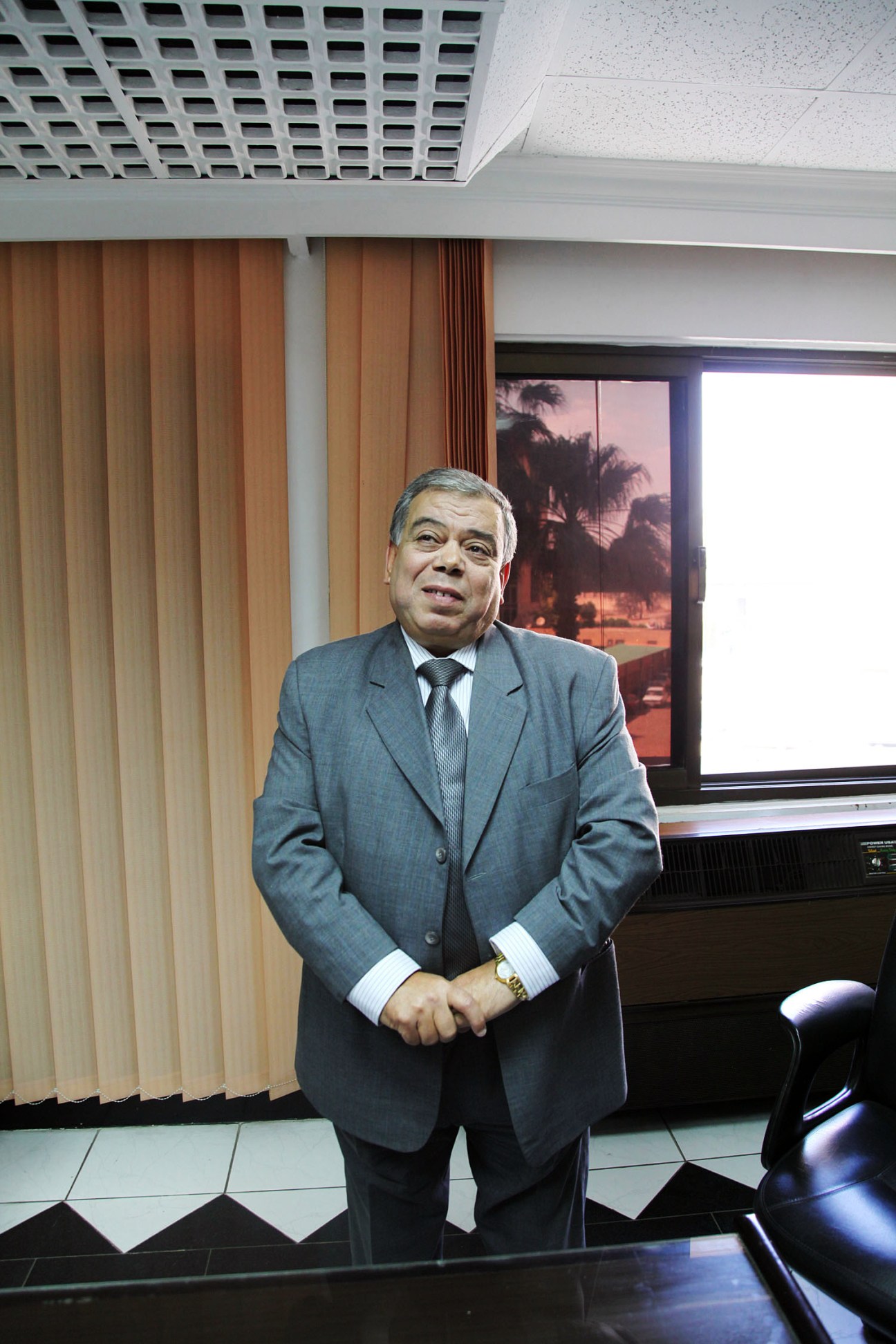 Ahmed Ali, head of Cairo's Cleanliness and Beautification Agency, standing in an office.