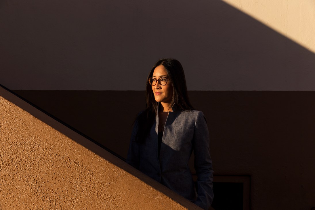 Lisa Nishimura, Netflix's head of documentaries, standing against a textured wall with dramatic lighting.