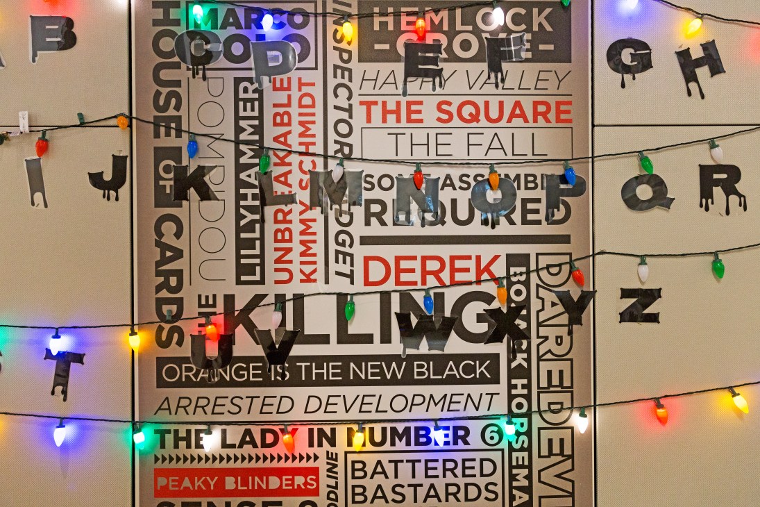 Office wall display with colorful text and string lights referencing Netflix's Stranger Things series