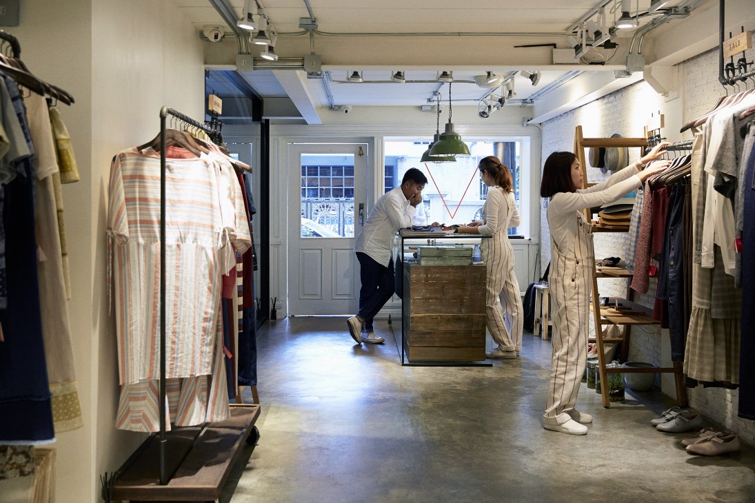 Staff members browse and arrange clothing inside Vick's flagship store on Soi Ari 2 in Bangkok.