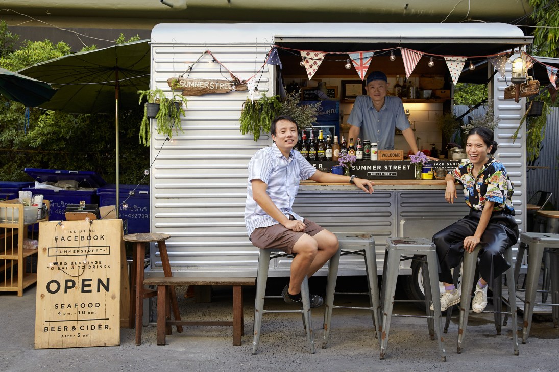 Staff pose outside Summer Street food truck in Bangkok's Ari neighborhood