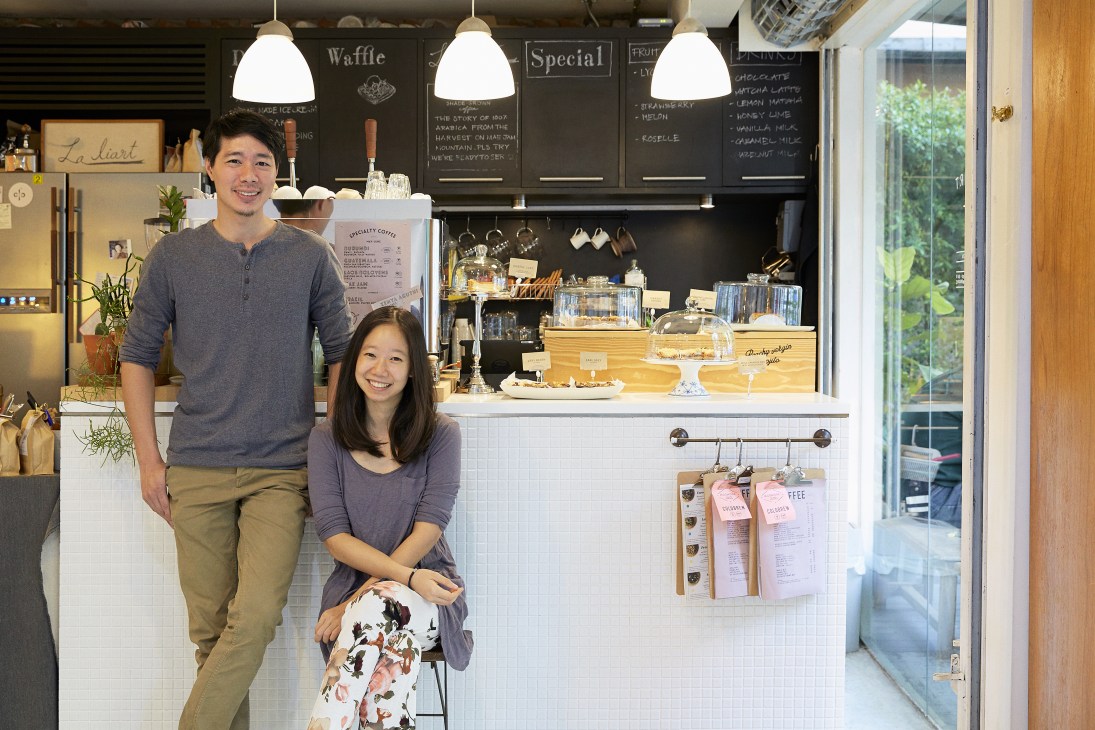 Two people standing behind the counter of Laliart Coffee in Bangkok's Ari neighbourhood.